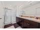 Bright bathroom featuring double sinks, ample cabinet space, and a modern glass-enclosed shower at 2907 Sime St, New Smyrna Beach, FL 32168