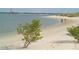 A tranquil beach scene with a couple strolling along the shoreline, with lush vegetation and a lighthouse at 2907 Sime St, New Smyrna Beach, FL 32168