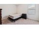 Bedroom with a twin bed with black frame and a dark dresser near a window at 2907 Sime St, New Smyrna Beach, FL 32168