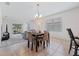 Cozy dining area with table and chairs, flowing into a bright living room with sliding glass doors at 2907 Sime St, New Smyrna Beach, FL 32168