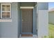 Welcoming front door with sidelight and covered entry, offering a glimpse of the home's charming exterior at 2907 Sime St, New Smyrna Beach, FL 32168
