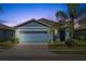 Charming single-story home with a well-maintained lawn, mature landscaping, and an attached two-car garage at 2907 Sime St, New Smyrna Beach, FL 32168