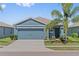 Charming single-story home with a well-maintained lawn, mature landscaping, and an attached two-car garage at 2907 Sime St, New Smyrna Beach, FL 32168