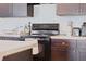 Close-up of the kitchen featuring dark countertops, appliances, and cabinets, perfect for culinary enthusiasts at 2907 Sime St, New Smyrna Beach, FL 32168