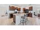 Well-lit kitchen featuring dark cabinets, a center island with seating, and modern appliances at 2907 Sime St, New Smyrna Beach, FL 32168