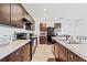 Spacious kitchen featuring dark cabinetry, modern appliances, granite countertops, and a tile backsplash at 2907 Sime St, New Smyrna Beach, FL 32168