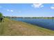Scenic view of the lake with a manicured grass shore and residences along the opposite bank at 2907 Sime St, New Smyrna Beach, FL 32168