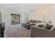 Comfortable living room with plush seating, a stylish ottoman, and a scenic outdoor view at 2907 Sime St, New Smyrna Beach, FL 32168