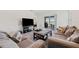 Inviting living room with comfortable seating and a view of the outdoor patio and serene lake at 2907 Sime St, New Smyrna Beach, FL 32168