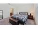 Well-lit main bedroom with a comfortable bed, side tables, and a glimpse of the en-suite bathroom at 2907 Sime St, New Smyrna Beach, FL 32168