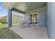 Covered patio with concrete floors, outdoor table and seating, and sliding glass doors at 2907 Sime St, New Smyrna Beach, FL 32168