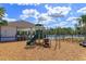 A playground features a play structure with slides and climbing equipment, located near the community pool at 2907 Sime St, New Smyrna Beach, FL 32168