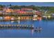 A waterfront restaurant with outdoor seating, docks, boats, and people enjoying the evening by the water at 2907 Sime St, New Smyrna Beach, FL 32168