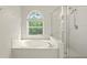 Bathroom with a soaking tub, separate shower, and a window providing natural light at 2987 Sabel Oak Pl, Oviedo, FL 32765
