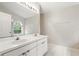 Bathroom features a double sink vanity, tile flooring, and a window for natural light at 2987 Sabel Oak Pl, Oviedo, FL 32765