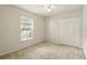 Bedroom with a window, bi-fold closet doors, and neutral carpet at 2987 Sabel Oak Pl, Oviedo, FL 32765