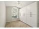 Bedroom with a large closet system, neutral carpet, ceiling fan, and a window view at 2987 Sabel Oak Pl, Oviedo, FL 32765