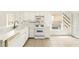 Kitchen with white cabinets and appliances, bright lighting, tile flooring, and lots of counter space at 2987 Sabel Oak Pl, Oviedo, FL 32765