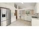 Bright kitchen features stainless steel appliances, white cabinetry, and tile flooring at 2987 Sabel Oak Pl, Oviedo, FL 32765