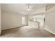 Bright living room with neutral carpet, ceiling fan, and open access to the kitchen at 2987 Sabel Oak Pl, Oviedo, FL 32765