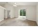 Spacious living room with a ceiling fan and sliding glass doors to the outdoor patio at 2987 Sabel Oak Pl, Oviedo, FL 32765