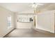 Living room with view of kitchen featuring white cabinets, tile floors, and stainless steel appliances at 2987 Sabel Oak Pl, Oviedo, FL 32765