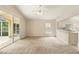 Open living room with sliding glass doors to a screened patio and an open view to the kitchen at 2987 Sabel Oak Pl, Oviedo, FL 32765