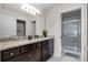 Bathroom with granite vanity, double sinks, and a clear glass shower at 301 Jetty Way, Davenport, FL 33897