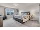 Spacious bedroom with a king size bed, large windows and neutral color scheme at 301 Jetty Way, Davenport, FL 33897