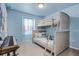 Light blue bedroom featuring a bunk bed, piano, and sheer curtains at 301 Jetty Way, Davenport, FL 33897