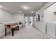Spacious bonus room with foosball table, TV, and laundry appliances creates a flexible space at 301 Jetty Way, Davenport, FL 33897