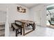 Cozy dining area with a rustic wooden table and bench seating, creating an inviting space for meals at 301 Jetty Way, Davenport, FL 33897