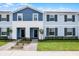 Charming two-story townhome with light blue siding, a well-kept lawn, and appealing front entryway at 301 Jetty Way, Davenport, FL 33897