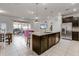 Open-concept kitchen with granite countertops, stainless steel appliances, and seamless flow to the living area at 301 Jetty Way, Davenport, FL 33897