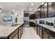 Stylish kitchen features dark cabinetry, stainless steel appliances, and sleek countertops, blending style and functionality at 301 Jetty Way, Davenport, FL 33897