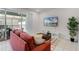 Comfortable living room with a flat-screen TV and sliding glass door to the screened-in lanai at 301 Jetty Way, Davenport, FL 33897