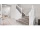 Carpeted staircase with white railings provides access to the upper level of the home at 301 Jetty Way, Davenport, FL 33897