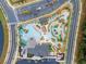 Aerial view of community pool featuring a lazy river, large pool, cabanas, and various water features at 3191 Paradox Cir # 401, Kissimmee, FL 34746