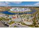 Aerial view showcasing a resort style community pool, splashpad, and surrounding residential buildings at 3191 Paradox Cir # 401, Kissimmee, FL 34746