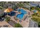 Aerial view of the community pool area, including a splashpad, lounge chairs, and outdoor seating at 3191 Paradox Cir # 401, Kissimmee, FL 34746