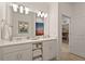 Bright double sink bathroom with white cabinets, quartz countertops and Disney themed decor at 3191 Paradox Cir # 401, Kissimmee, FL 34746