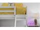 This stylish bedroom features bright yellow bedding, a unique vase table lamp, and a trendy neon sign at 3191 Paradox Cir # 401, Kissimmee, FL 34746