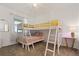 Bright bedroom features a carpeted floor, white bunk beds with yellow and green accents, and stylish decor at 3191 Paradox Cir # 401, Kissimmee, FL 34746