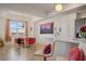 Bright dining area with modern table, colorful chairs, chandelier, and bar seating at the kitchen counter at 3191 Paradox Cir # 401, Kissimmee, FL 34746