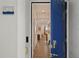 Entryway featuring a blue door into a tiled hall with an open view of the living room and window at 3191 Paradox Cir # 401, Kissimmee, FL 34746