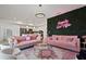 Open-concept living room with pink sofas, kitchen, and chic decor with modern lighting fixtures at 3191 Paradox Cir # 401, Kissimmee, FL 34746