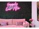 Comfortable living room with a pink sofa and a stylish neon light wall decoration at 3191 Paradox Cir # 401, Kissimmee, FL 34746