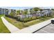 Apartment complex with a fenced pool, surrounding landscaping, lounge chairs and a clubhouse with parking at 3191 Paradox Cir # 401, Kissimmee, FL 34746