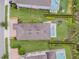 Aerial view of a backyard featuring a pool, patio furniture, and manicured landscaping at 321 Falls Dr, Kissimmee, FL 34747