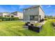Backyard featuring a pool, spa, lounge area, and well-maintained lawn at 321 Falls Dr, Kissimmee, FL 34747